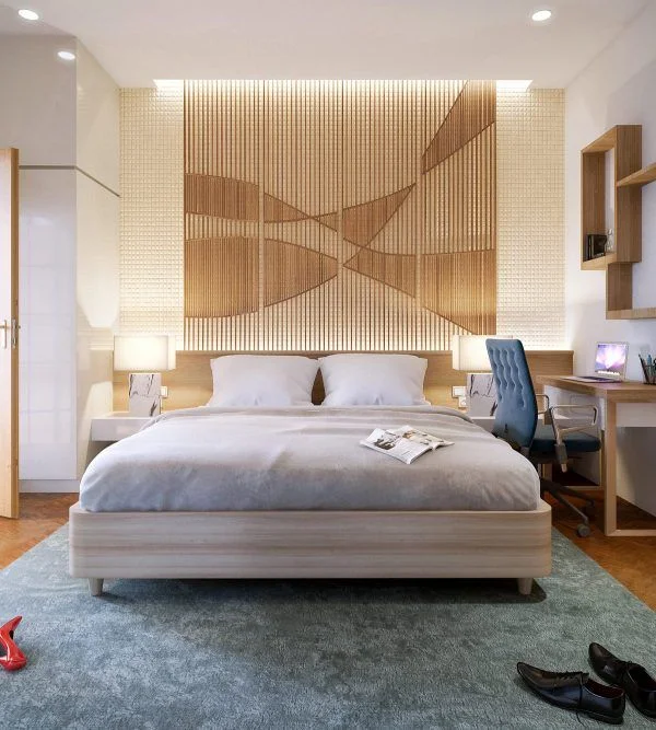 A bedroom has a geometric accent wall with vertical lines behind a pale bed and two bedside lamps.