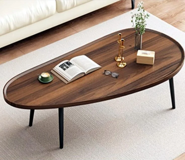 An oval wood-grain coffee table stands on black tapered legs.