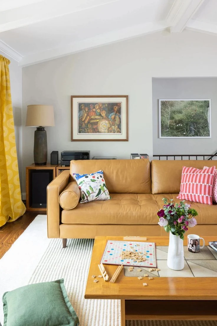 A tan sofa pairs with a low wooden coffee table and pale rug.
